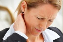 Professional Woman looking stressed and holding her neck