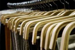 Skirts and trousers on clothes rail in a retail store