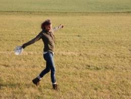 woman hiking in fields featured