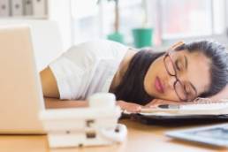 woman sleeping at her desk