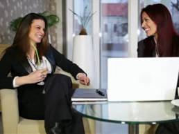 meeting-between-two-business-woman-at-a-desk-shallow-depth-of-field-thumb