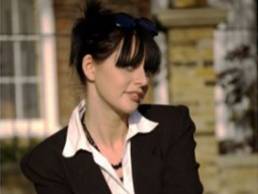 lady sitting outside house