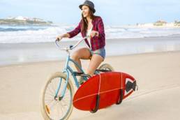 Woman riding a bike on the beach