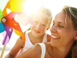 mother and daughter having fun at the beach featured