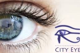 The City Eye Blog Logo - A picture of a woman's eye and the reflection of the London skyline reflected in her eye.