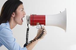 Woman shouting into megaphone Feature