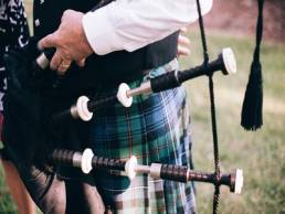 man playing bagpipes in kilt burn's night featured