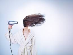 woman drying her hair featured