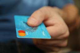 man paying with credit card featured