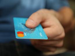 man paying with credit card featured
