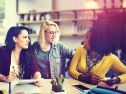 Women sitting together as a three chatting and discussing