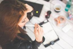 change woman thinking while writing in diary featured