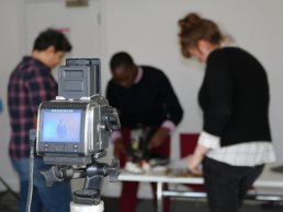camera pictured with group of people out of focus, same but different project featured