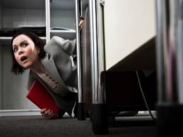 competitive workplace woman looking scared featured