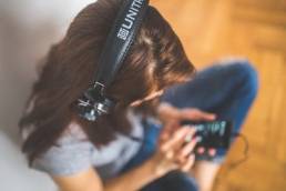 woman listening to music on her phone featured