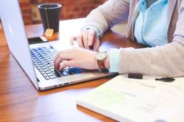 Woman working on a laptop featured
