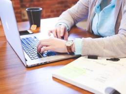 Woman working on a laptop featured