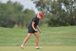 female golfer playing at golf club featured