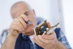male electrician working on a plug featured