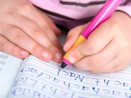 child learning to write featured