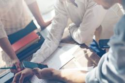 group of workers doing a presentation featured