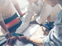 group of workers doing a presentation featured