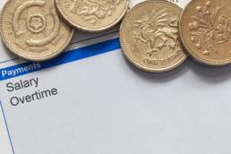 wage slip with pound coins featured