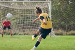 woman-playing-football-featured