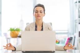 vbusiness-woman-meditating-at-her-desk-meditation-featured