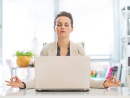 vbusiness-woman-meditating-at-her-desk-meditation-featured