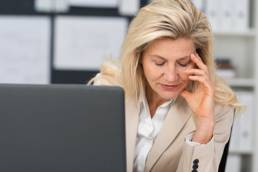 Blonde woman upset by her laptop, unhappy about the gender gap