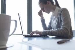 gender pay-gap woman stressed in desk