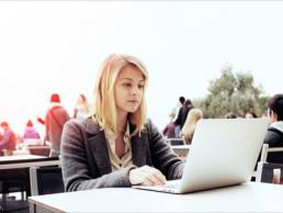 young attractive woman at her laptop searching for jobs