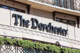 The Dorchester Hotel advertising logo sign outside its hotel in Park Lane Mayfair Hyde Park which is a popular travel destination tourist landmark of the city centre
