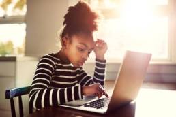 young-girl-working-on-a-computer-stem-featured