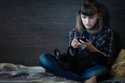 sad child on the phone, childline featured