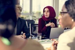 muslim lady wearing a headscarf at board meeting featured