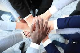 team holding hands, mental health featured