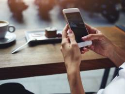 transgender woman holding mobile phone featured