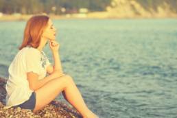 woman looking sad on holiday, breaking down featured