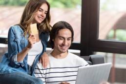 millennial couple paying for items featured
