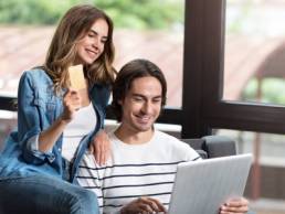 millennial couple paying for items featured