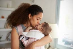 woman holding a baby featured