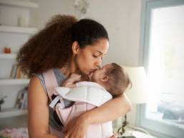 woman holding a baby featured