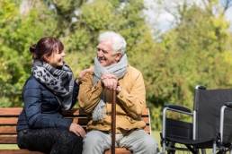 carer looking after elderly man featured