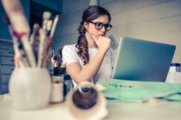 woman looking at laptop thinking, applying for jobs featured