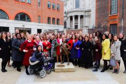 Gender Networks standing in front of the Fearless Girl statue