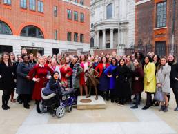 Gender Networks standing in front of the Fearless Girl statue
