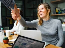 getting women into senior positions, woman shaking hands, handshake featured