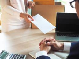 woman handing in her resignation, resigned, quitting, corporate life